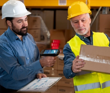 Warehouse workers scanning package